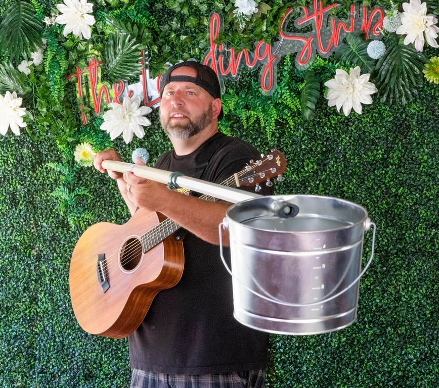 Brian Glowacki, with his tip bucket on a socially-distanced pole, has been playing gigs at The Saltbox Tavern and Table this summer.