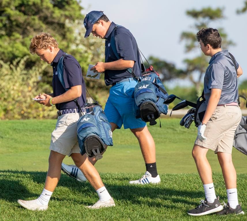 Captain Kai Ottani, left, and Will Harris, center, scoring their cards at Miacomet Golf Course.