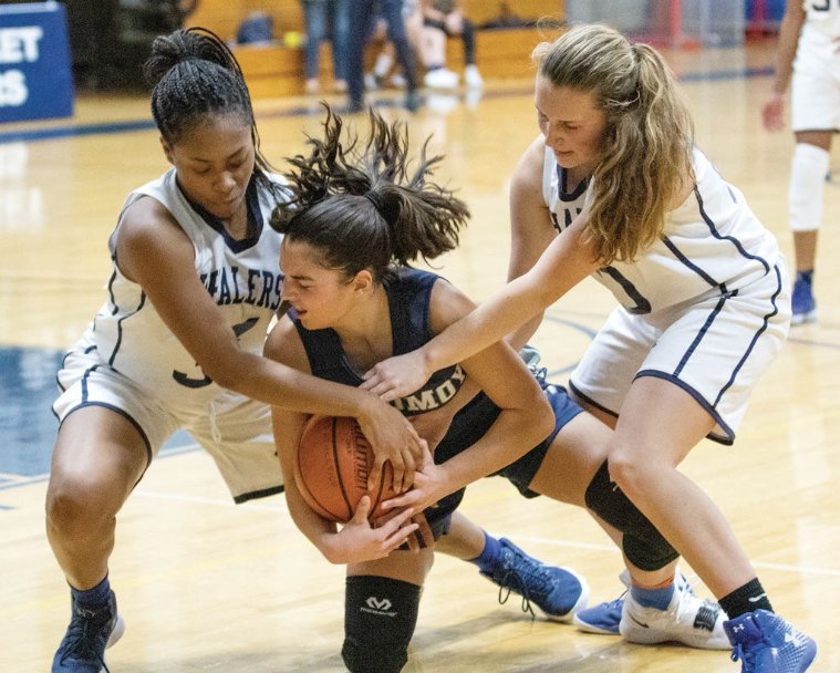 Madison Bird, left, and Anna Steadman tie up a loose ball in the fourth quarter of the Whalers' 38-37 home win over Monomoy last Wednesday.