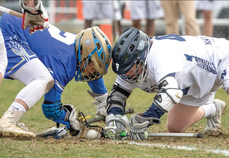 Austin Starr, right, faces off against St. John Paul II Tuesday in the Whalers' 20-2 win over the Lions. Nantucket, 6-0, will look to continue its undefeated early-season run after spring break against Nauset April 20.