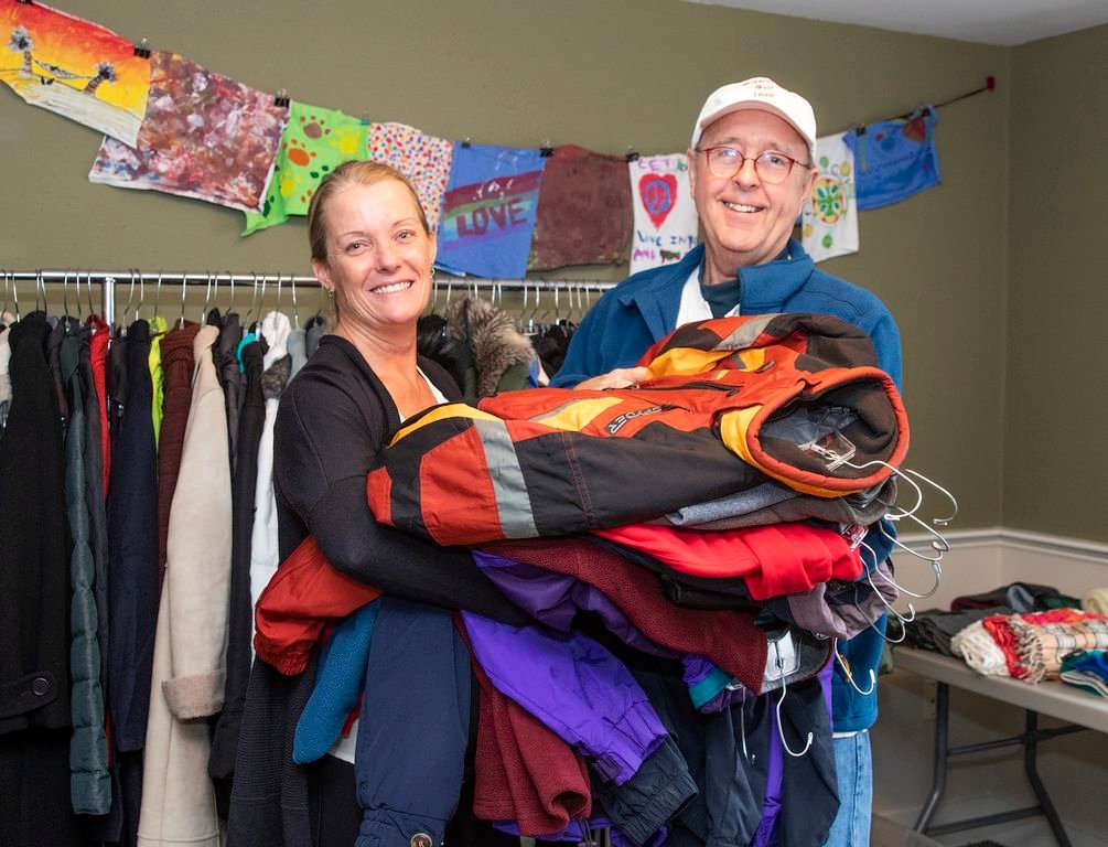 Elise Norton of the Nantucket Family Resource Center receives coats from Cris Farley as part of a winter clothing drive called the Christmas Clothing Cleanout to help island families in need. Clothing can be donated this Sunday at The Chicken Box on Dave Street starting at noon.