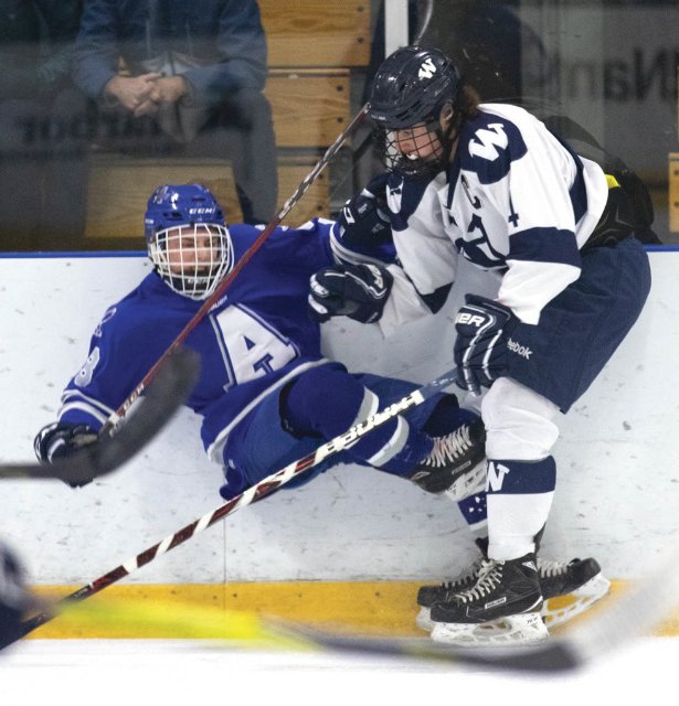 Senior captain Austin Starr checks an Attleboro player along the boards in the first period of Nantucket's 4-1 win in the preliminary round of the Div. 3 South playoffs Wednesday.