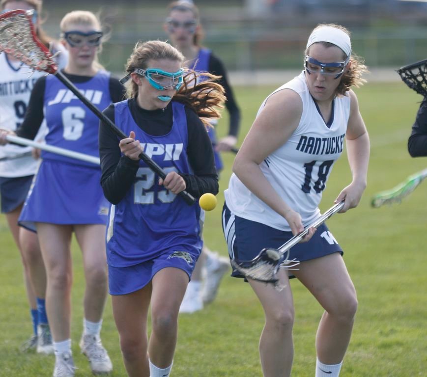 Paige Albertson, right, battles a St. John Paul II player for the ball earlier this season.