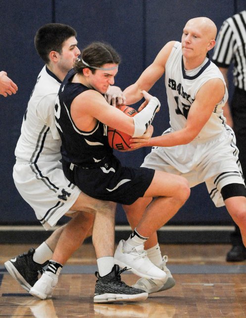 Victor Gamberoni is tied up by Jamie Routhier and Jason Ready of Monomoy during the Whalers' 51-39 win over the Sharks last Wednesday that secured Nantucket a share of the Cape &amp; Islands League title.