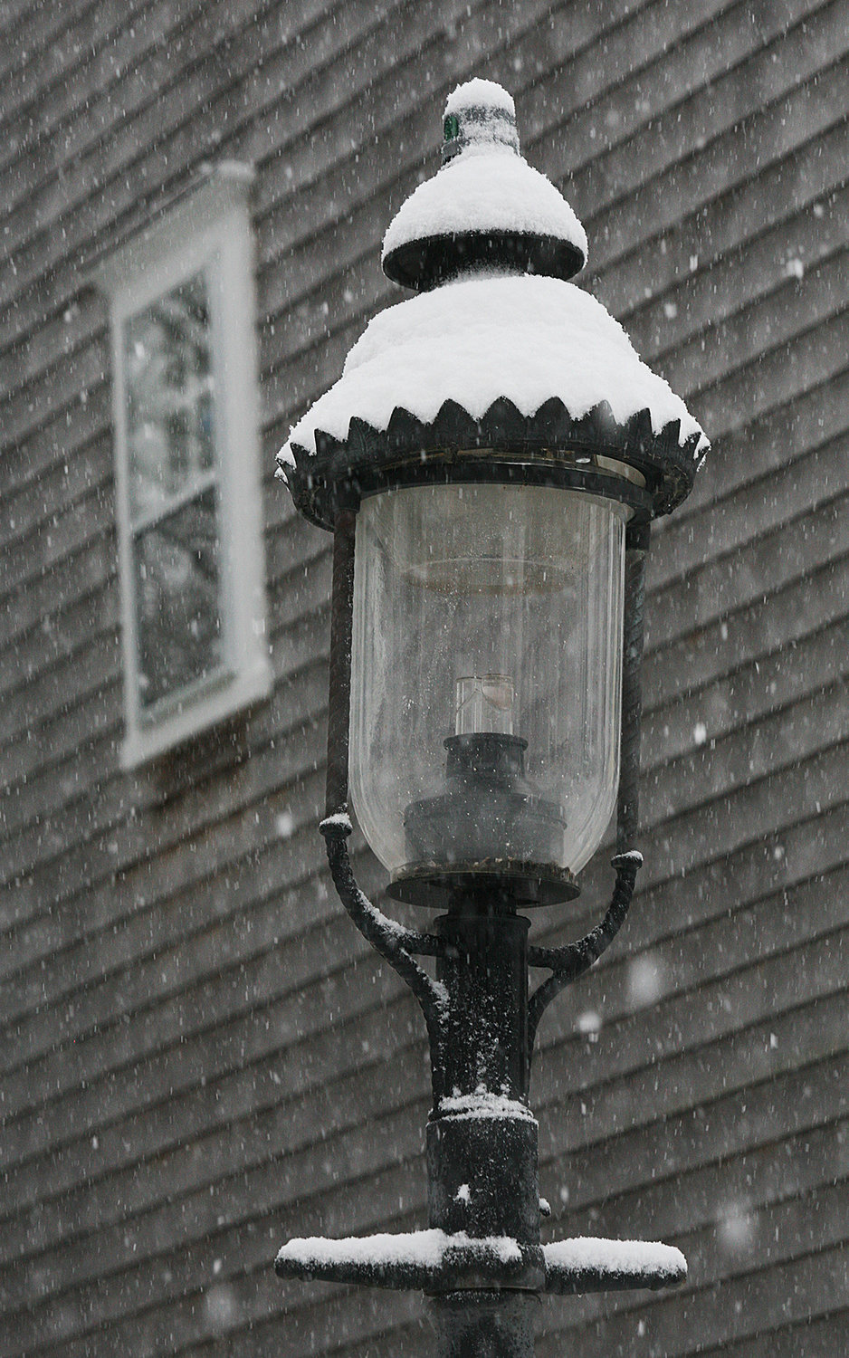 Snow coats a lamp on Centre Street.