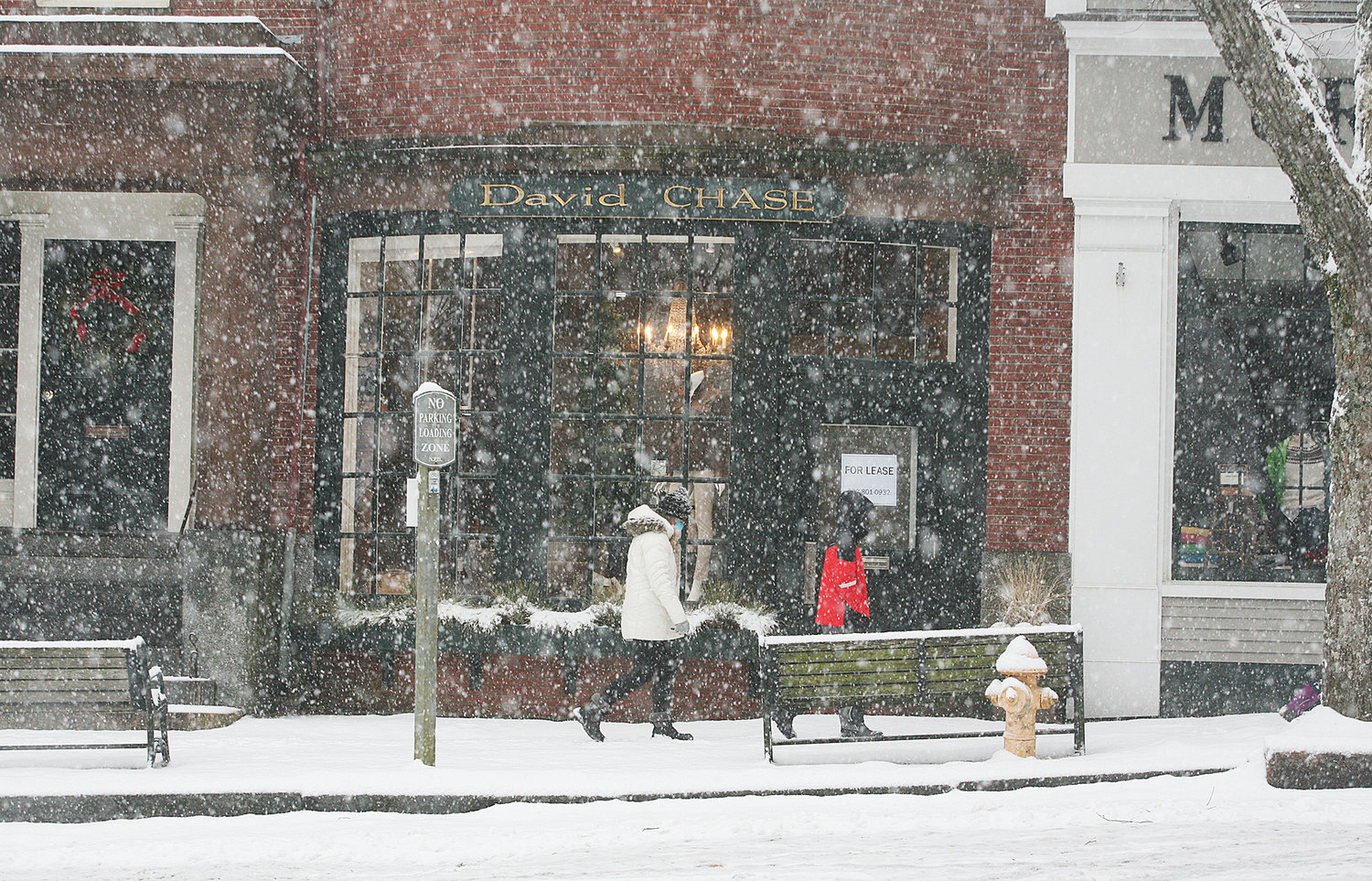 People make their past shops along Main Street during Thursday's snow.