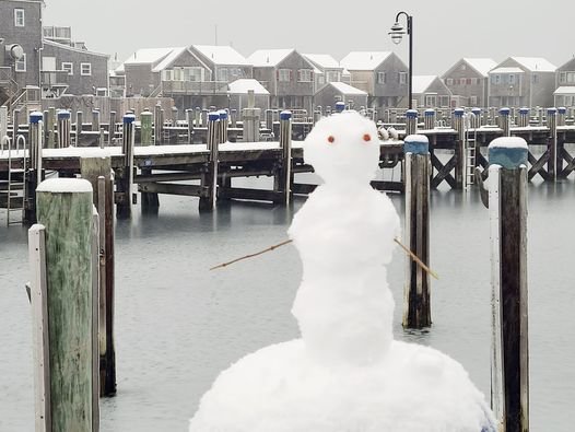 A snowman stands sentinel over the Nantucket Boat Basin.