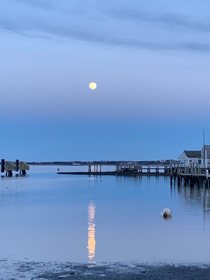 The moon reflected on Nantucket Harbor.