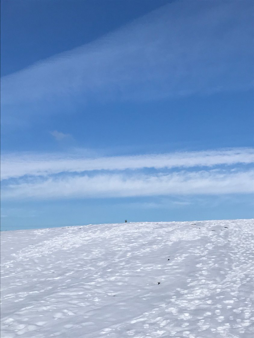 Blue sky over a sledding hill.