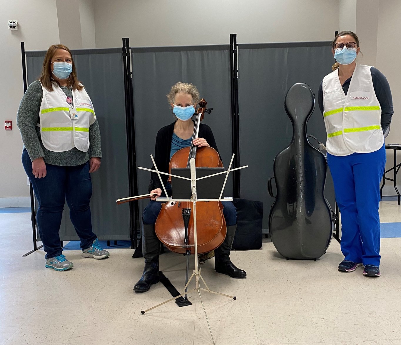 Cellist Mollie Glazer with Nantucket Cottage Hospital staff members Michele Cranston and Suzanne Carroll at the New South Road VFW vaccination site Monday.