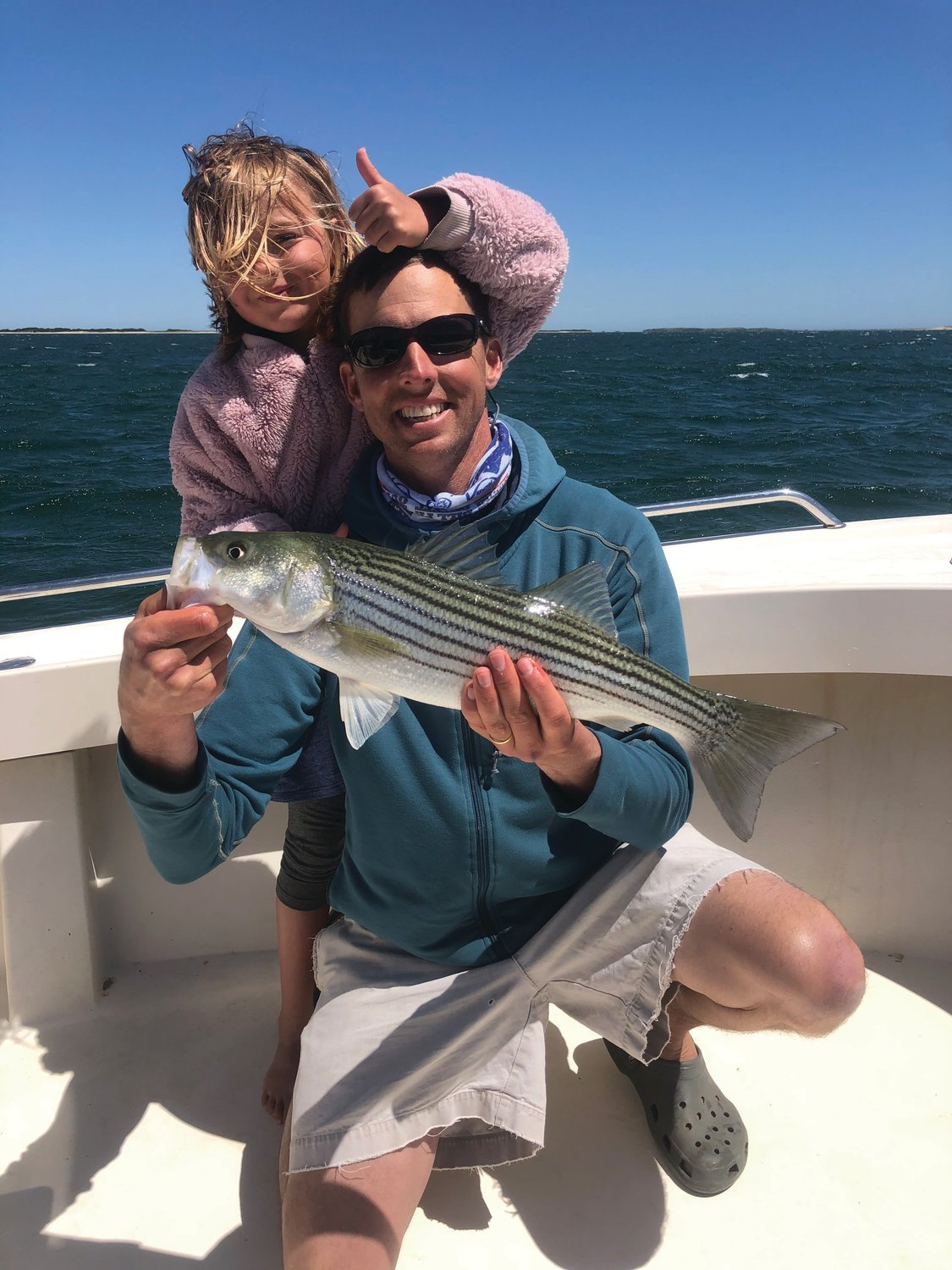 Cam and Morgan Gammill with an early-season striped bass they caught this week.