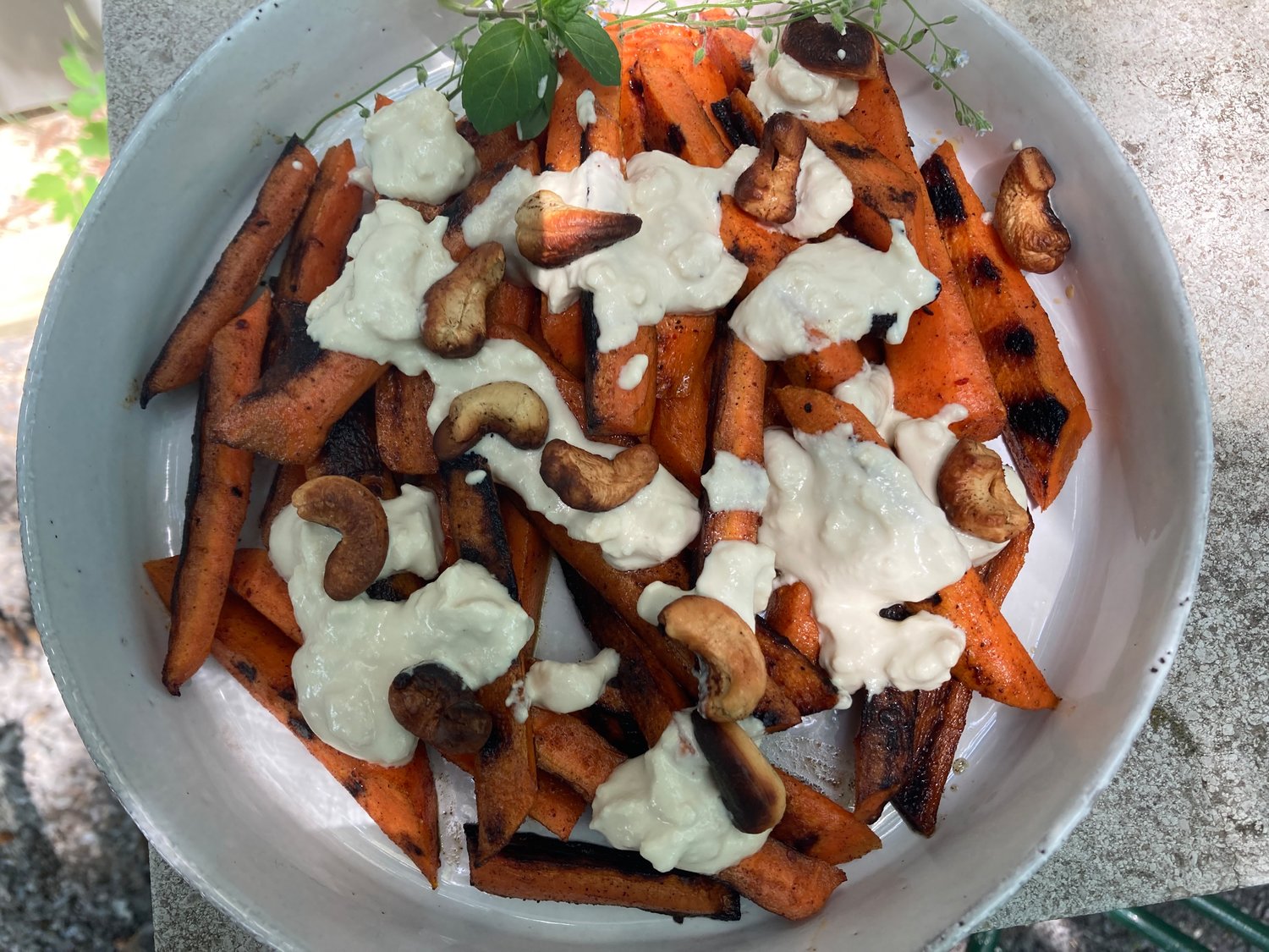 These mildly-grilled carrots are drizzled with cashew mayonnaise instead of conventional mayo.