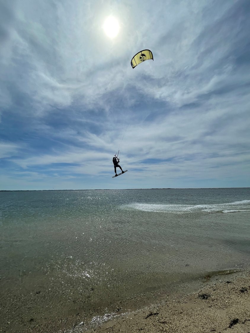 A kiteboarder catches big air over Pocomo Harbor.