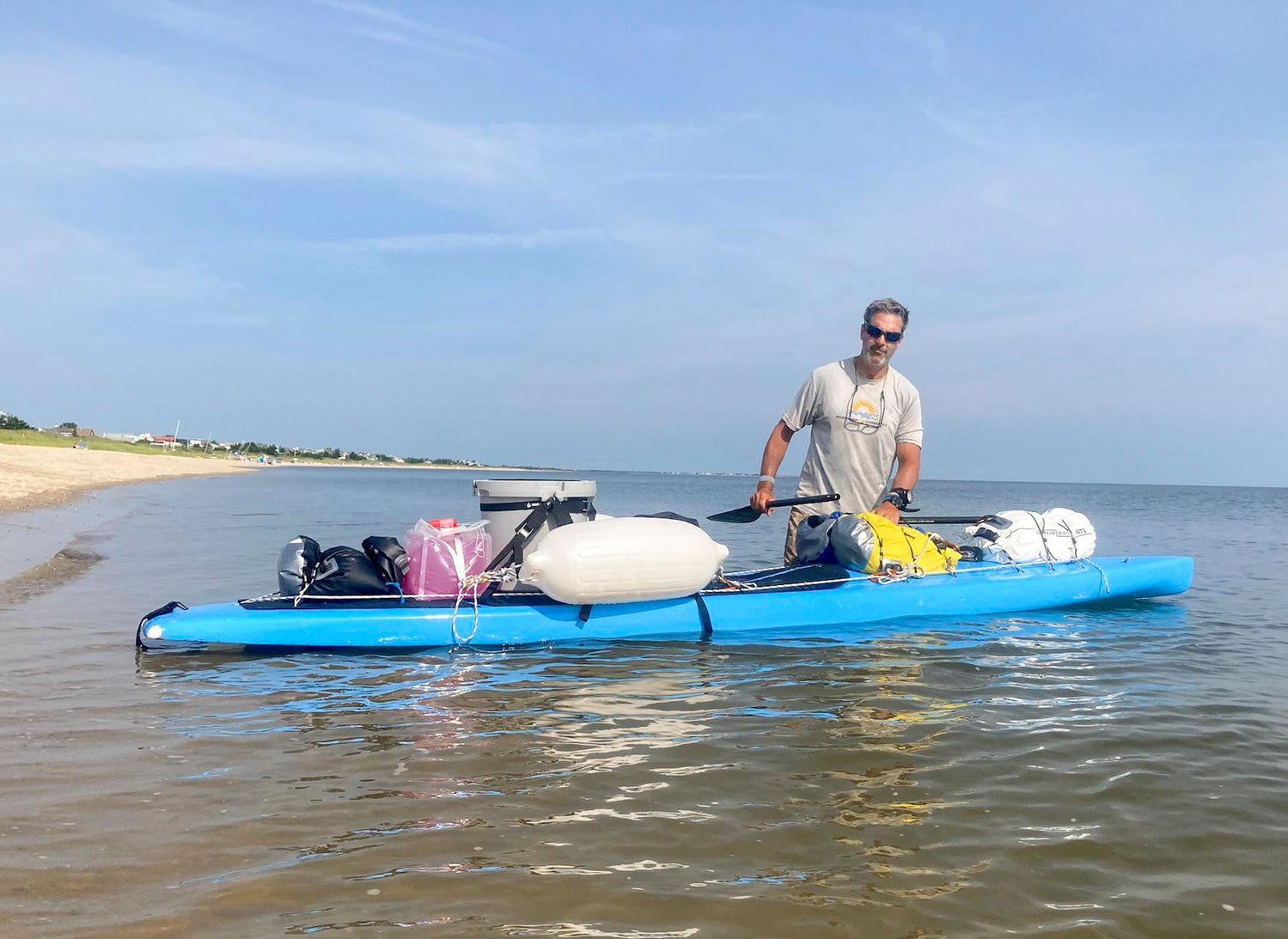 Adam Nagler preparing to set off from Rehoboth Beach, Del. Sunday on his 400-mile paddle-board journey to Nantucket.
