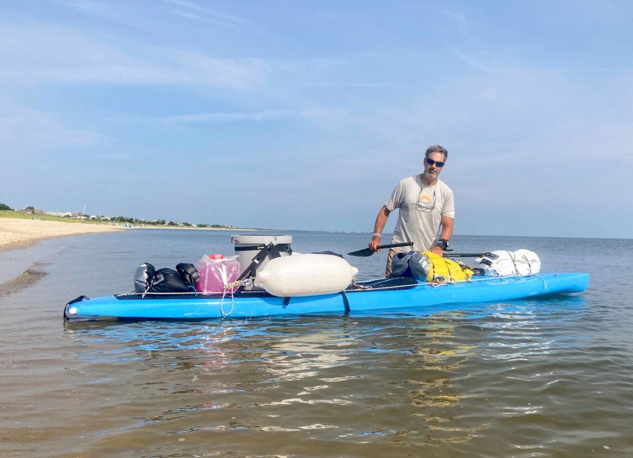 Adam Nagler preparing to set off from Rehoboth Beach, Del. Sunday on his 400-mile paddle-board journey to Nantucket.