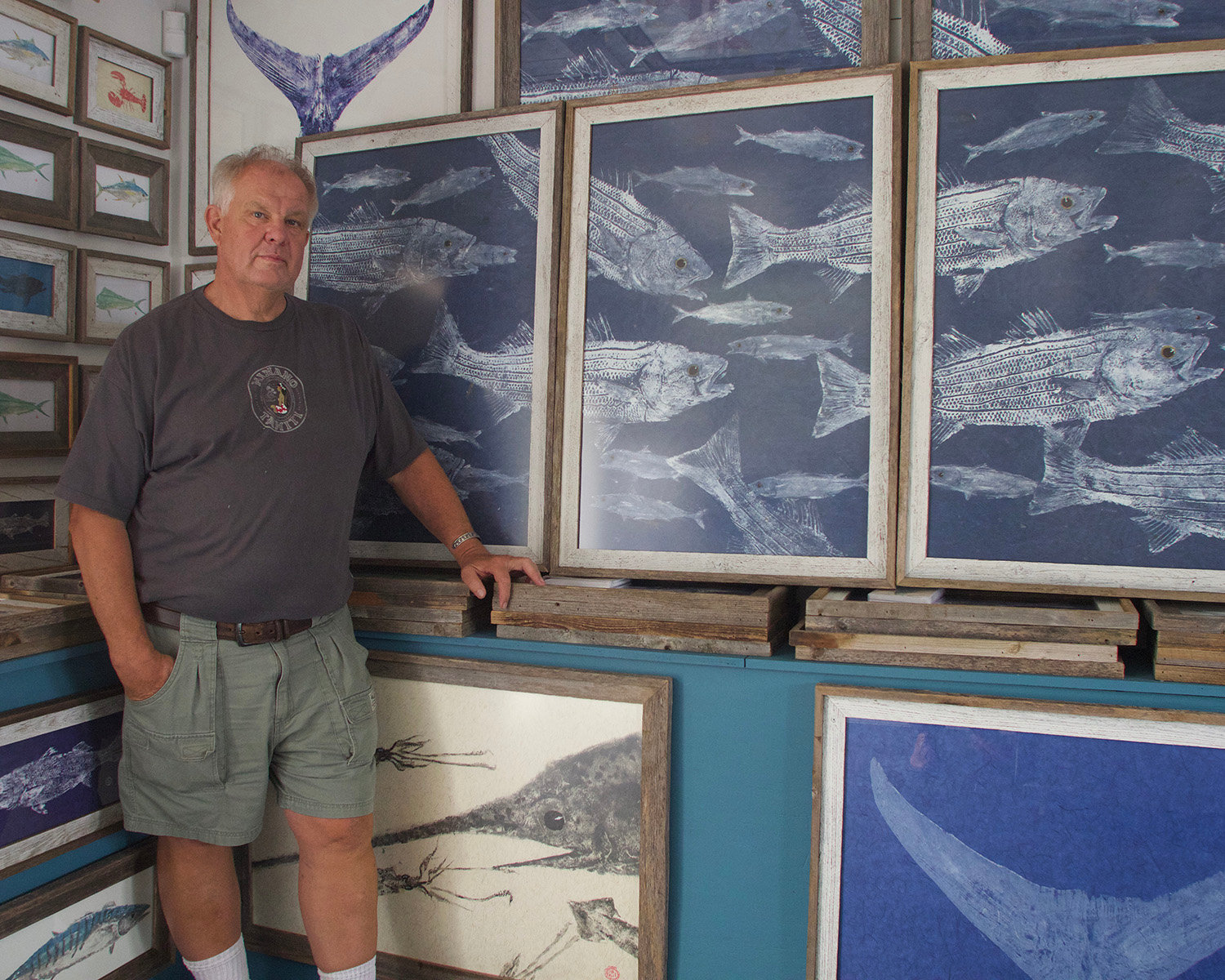 Peter Van Dingstee with some of the gyotaku prints he makes from recently-caught fish.