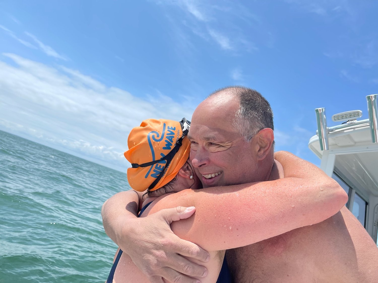 Deb Blair, the last person to complete a swim from island to island, in 2000, gives Doug McConnell a hug after he ended his swim.