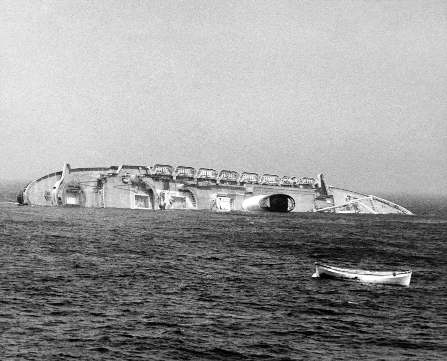 This photo, one of a series which won a Pulitzer Prize for photographer Harry Trask, shows the Andrea Doria in its final moments with an empty lifeboat in the foreground.