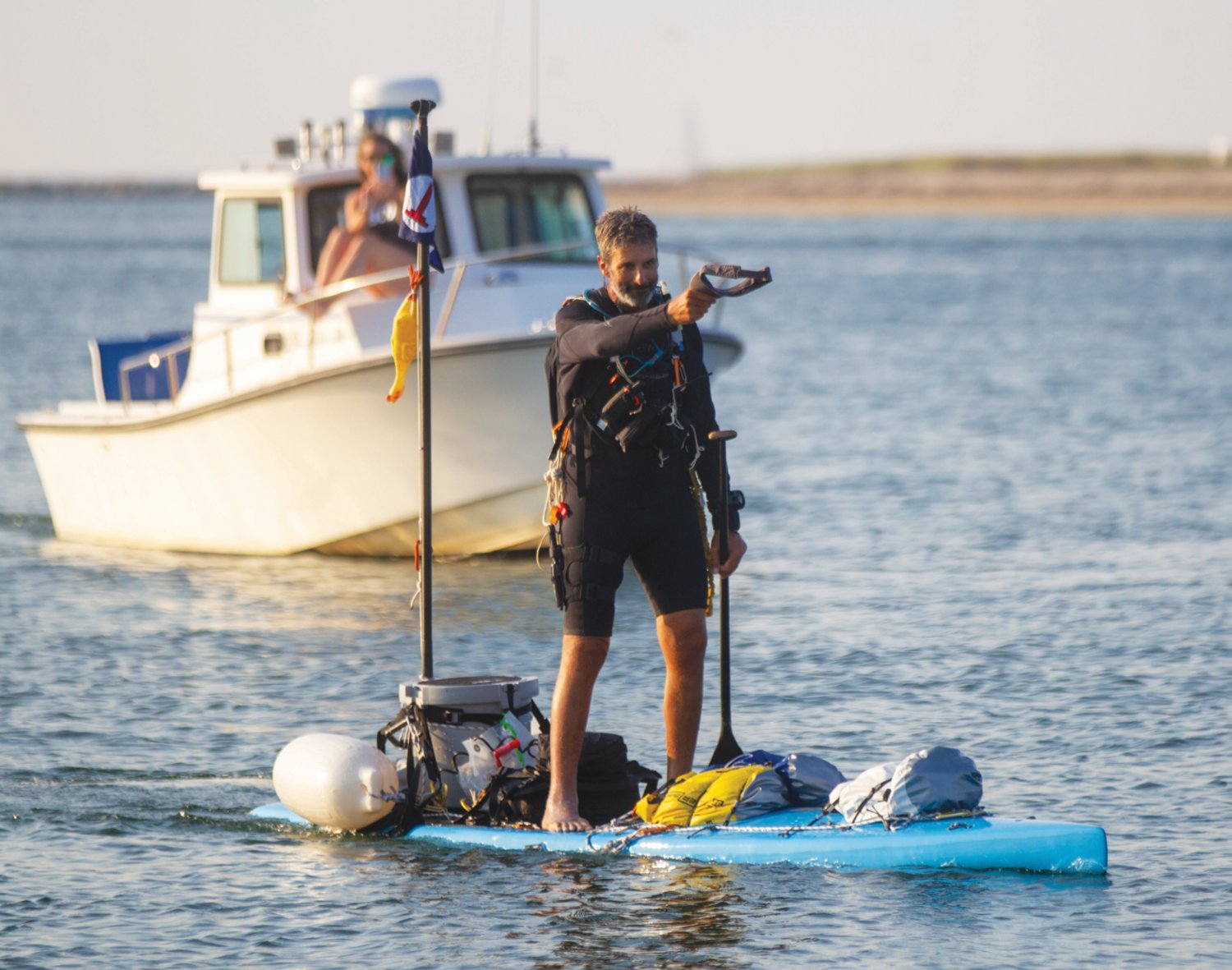 Paddle-boarder Adam Nagler approaches Brant Point Light on Nantucket early Tuesday evening, completing his 450-mile odyssey that began in southern Virginia.
