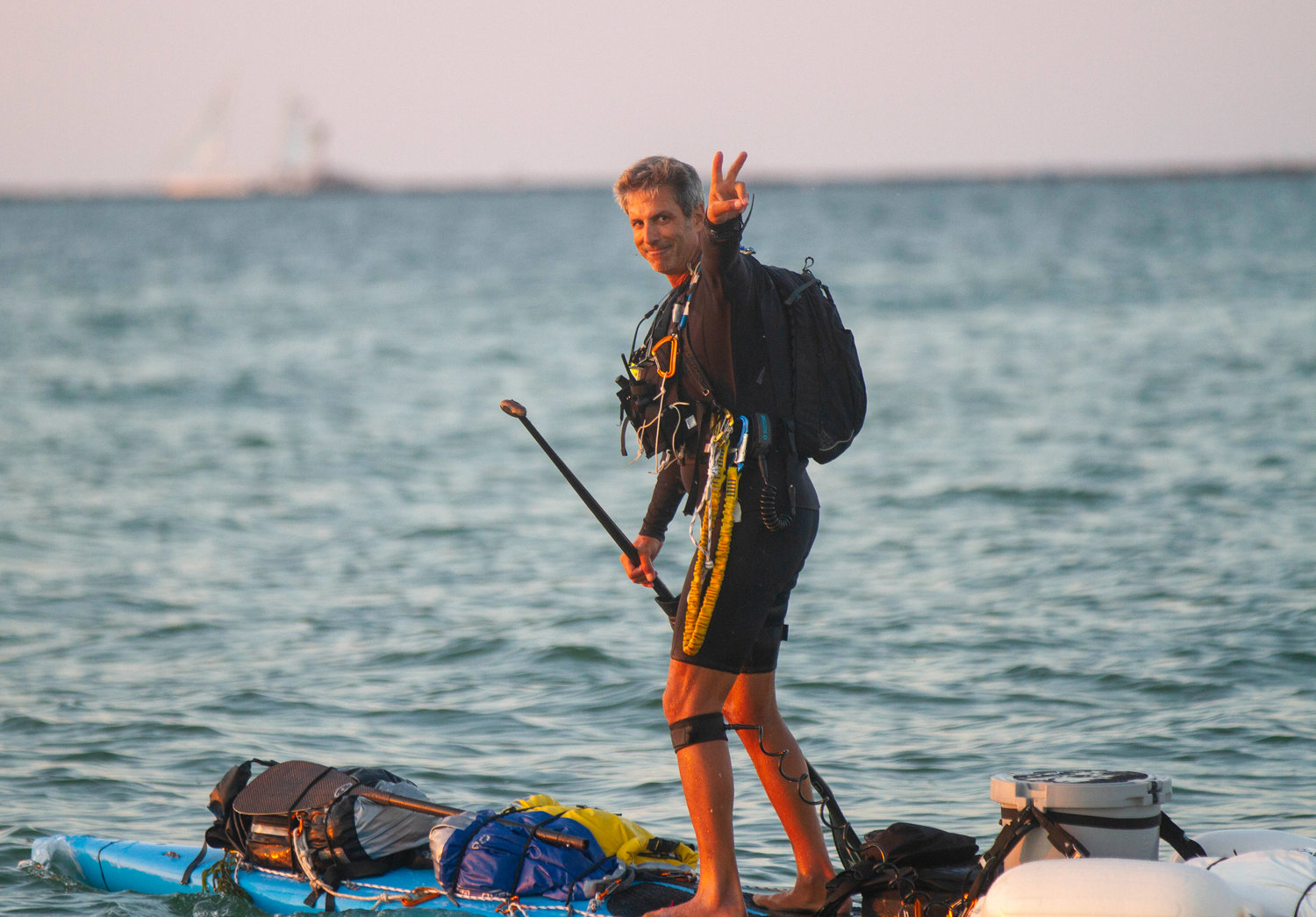 Adam Nagler flashes the peace sign as he departs from Nantucket Monday evening.