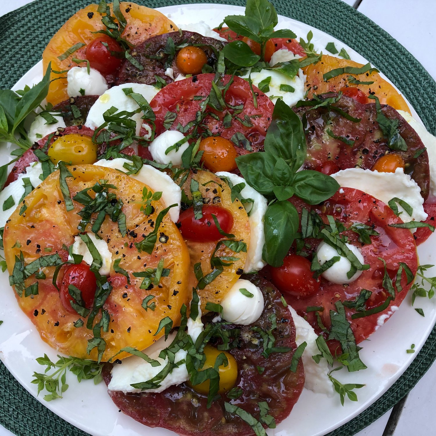 Unlike traditional Caprese Salads, this one is made with contrasting colors of heirloom tomatoes and two varieties of mozzarella cheese.