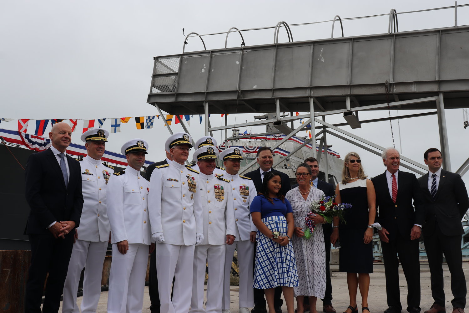 Nantucket town manager Libby Gibson, third from right, among the dignitaries at the christening of the USS Nantucket Saturday.