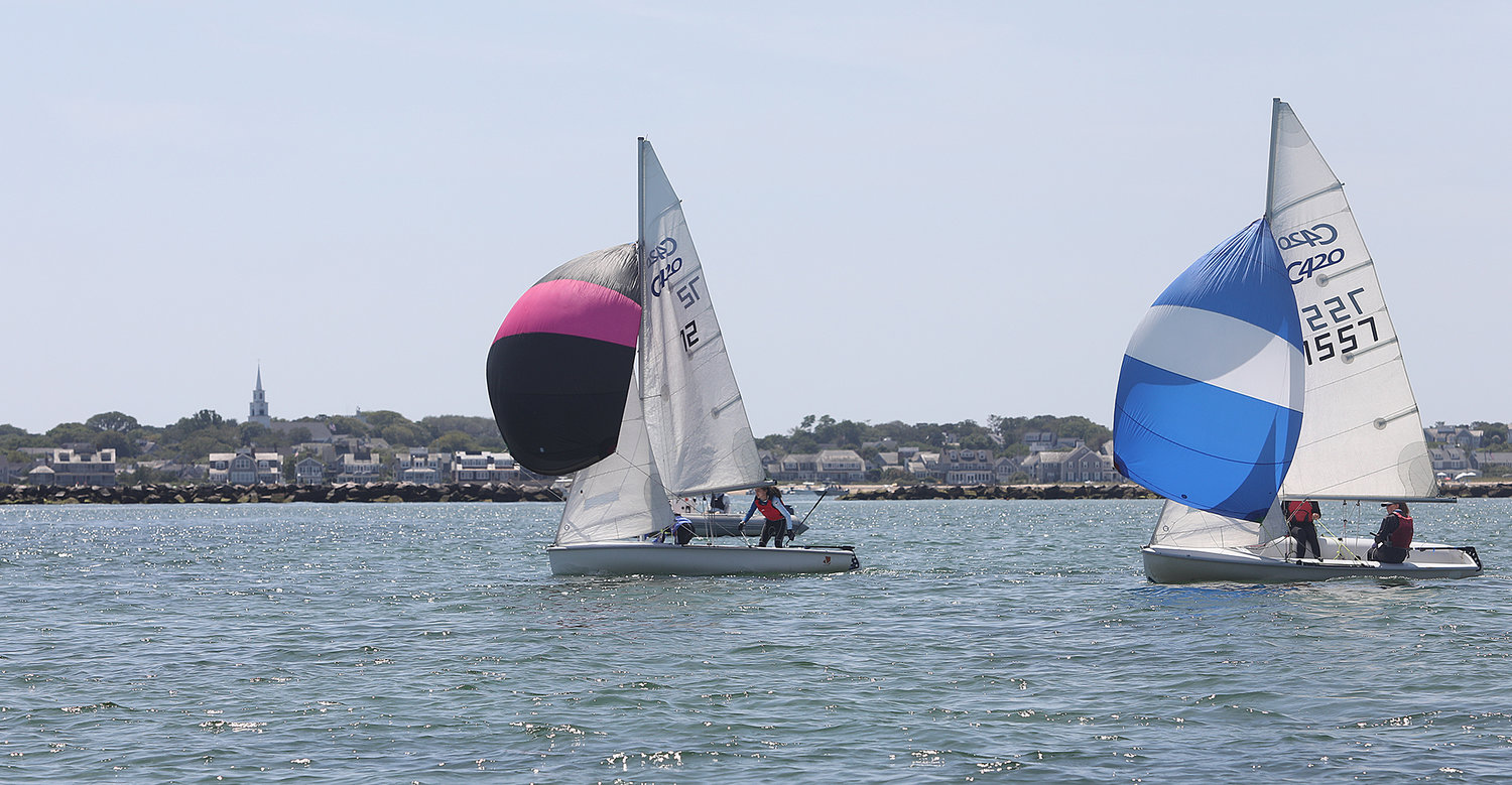 Spinnakers up on the downwind leg with the Nantucket skyline in the background during the first 420 race on Tuesday.
