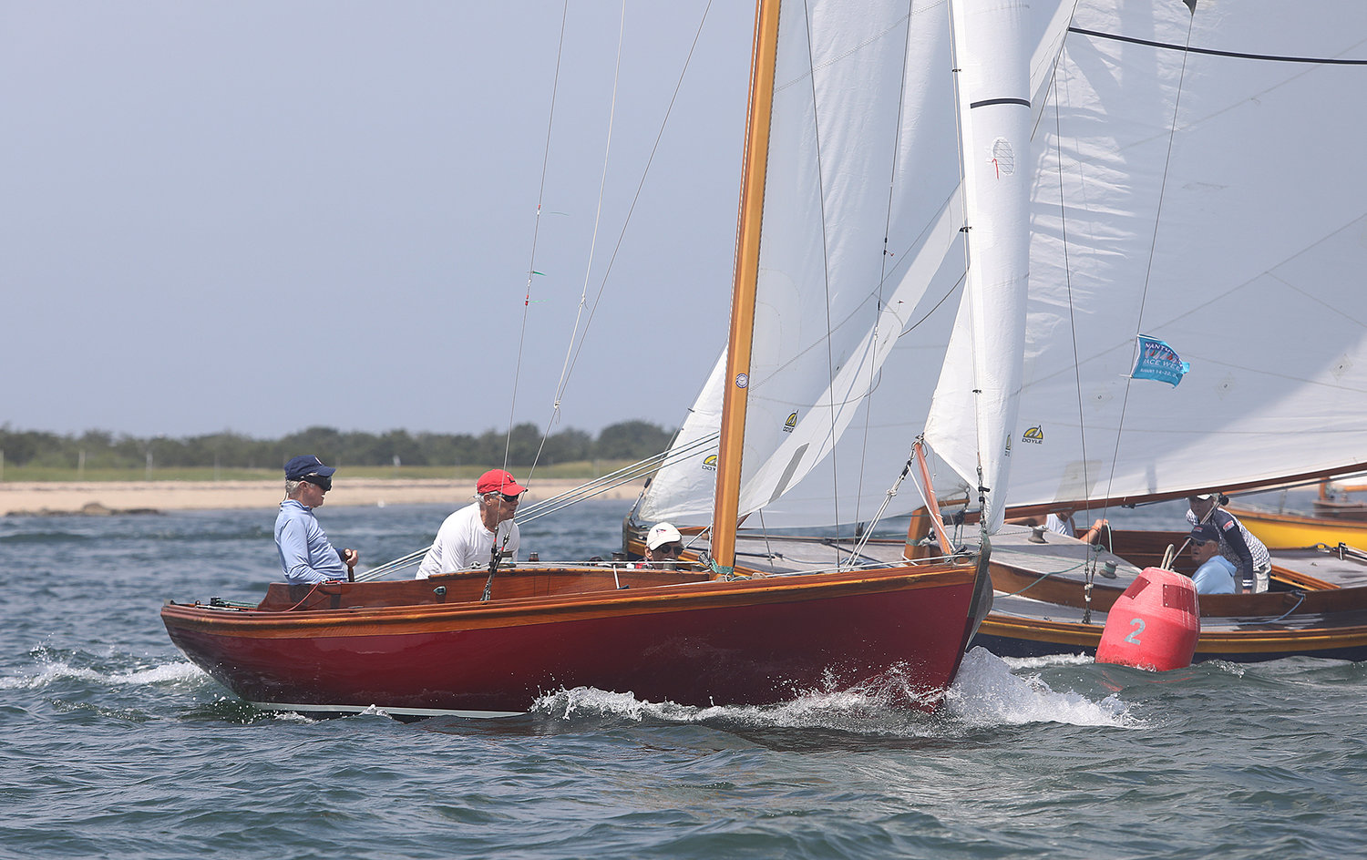 An Alerion rounds the windward mark during the One Design Regatta in Nantucket Harbor on the opening day of Race Week 2021.