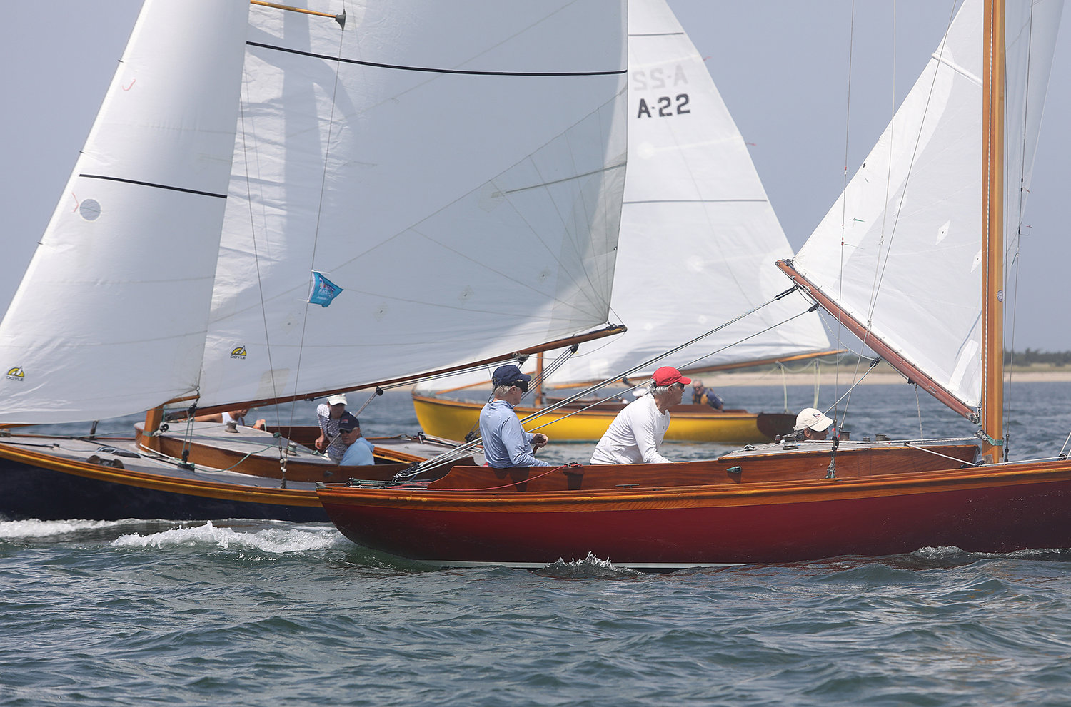 Alerions sailing close as they round the windward mark during the One Design Regatta in Nantucket Harbor on the opening day of Race Week 2021.