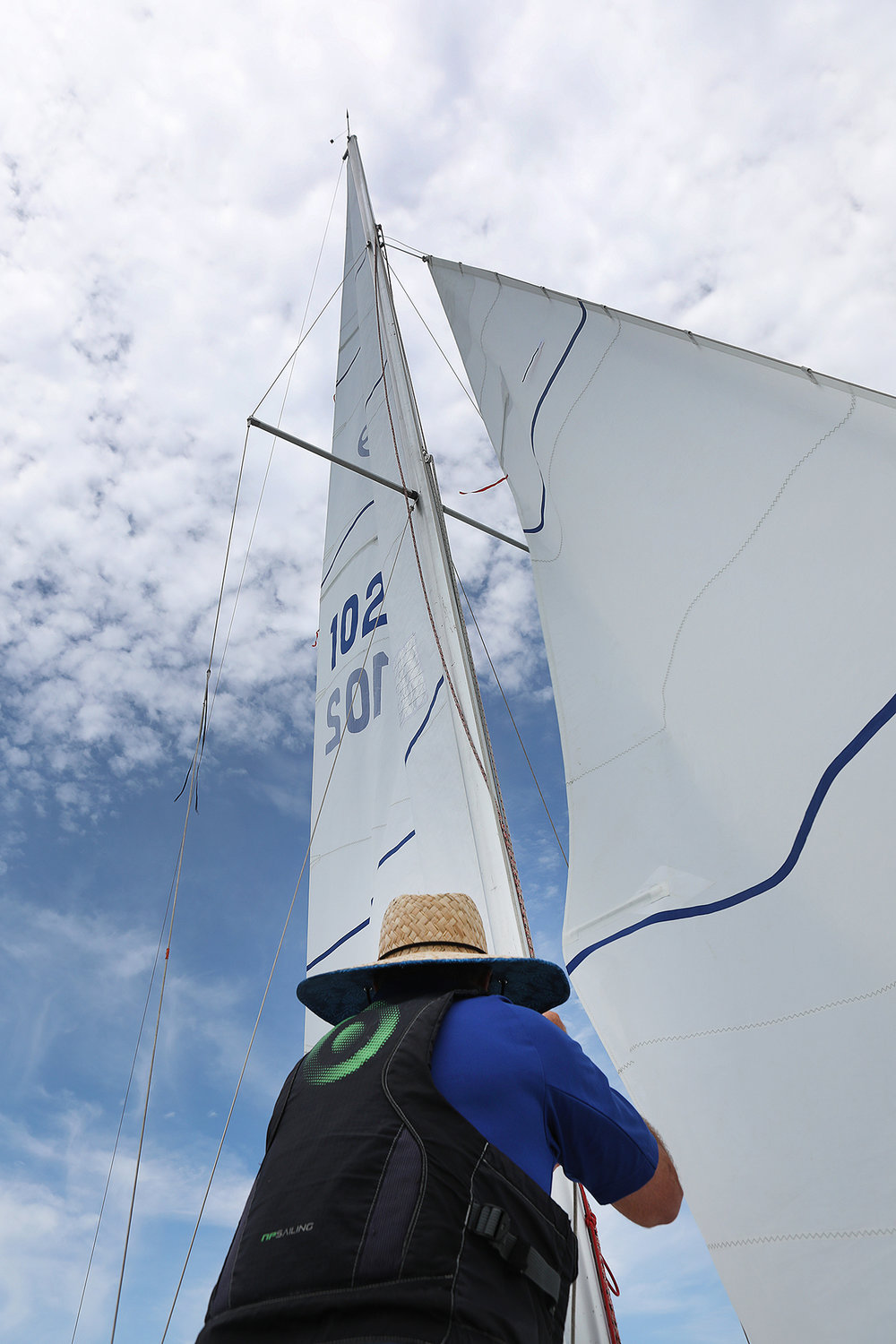 Justin Assad, Sailing Master for the Nantucket Yacht Club, helps a sail during the 2021 Women's Regatta in the harbor on Wednesday.