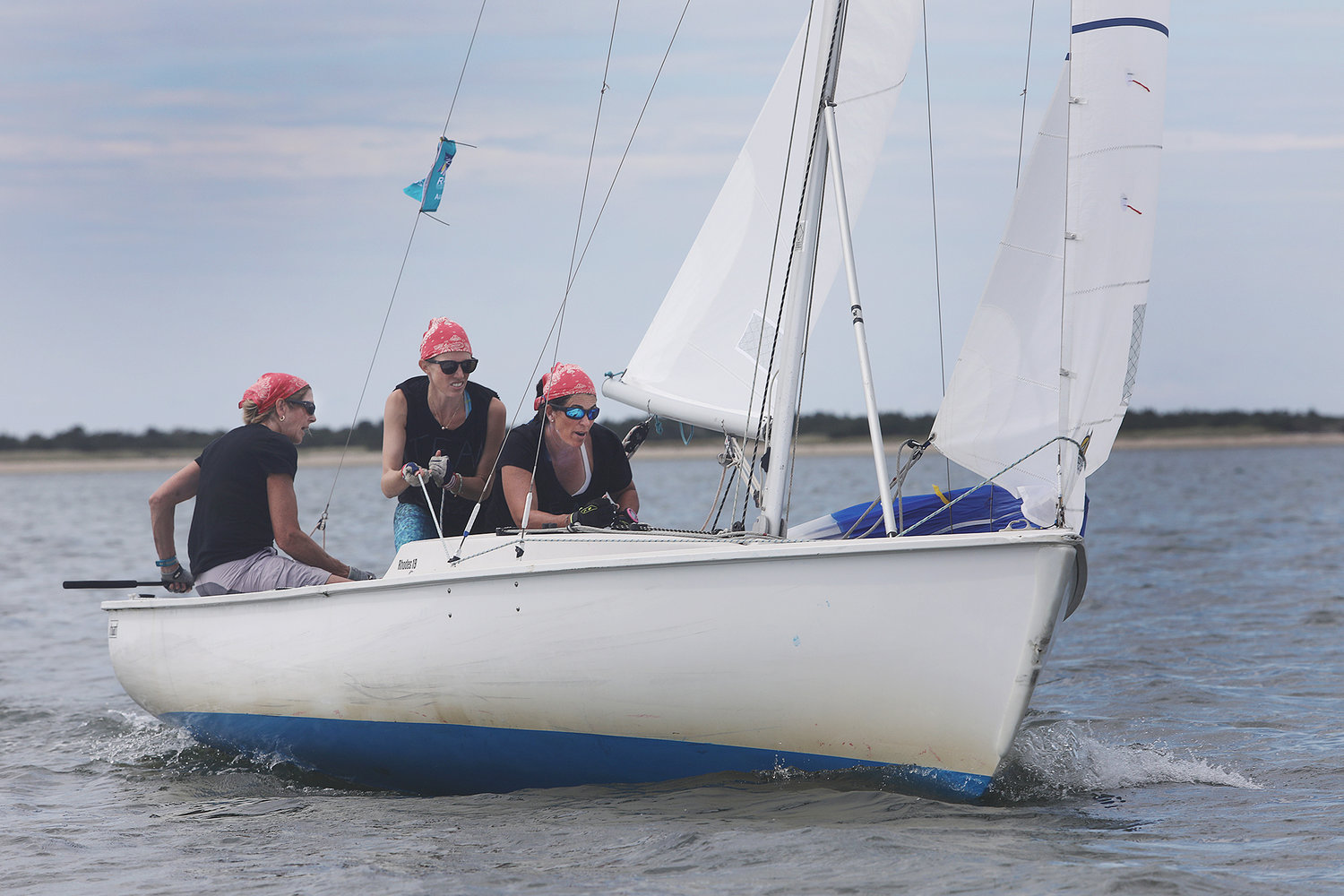 Sandy Adzick handles the tiller as Vanessa Coleman and Hollis von Summer trim the sails during the 2021 Women's Regatta in the harbor on Wednesday.