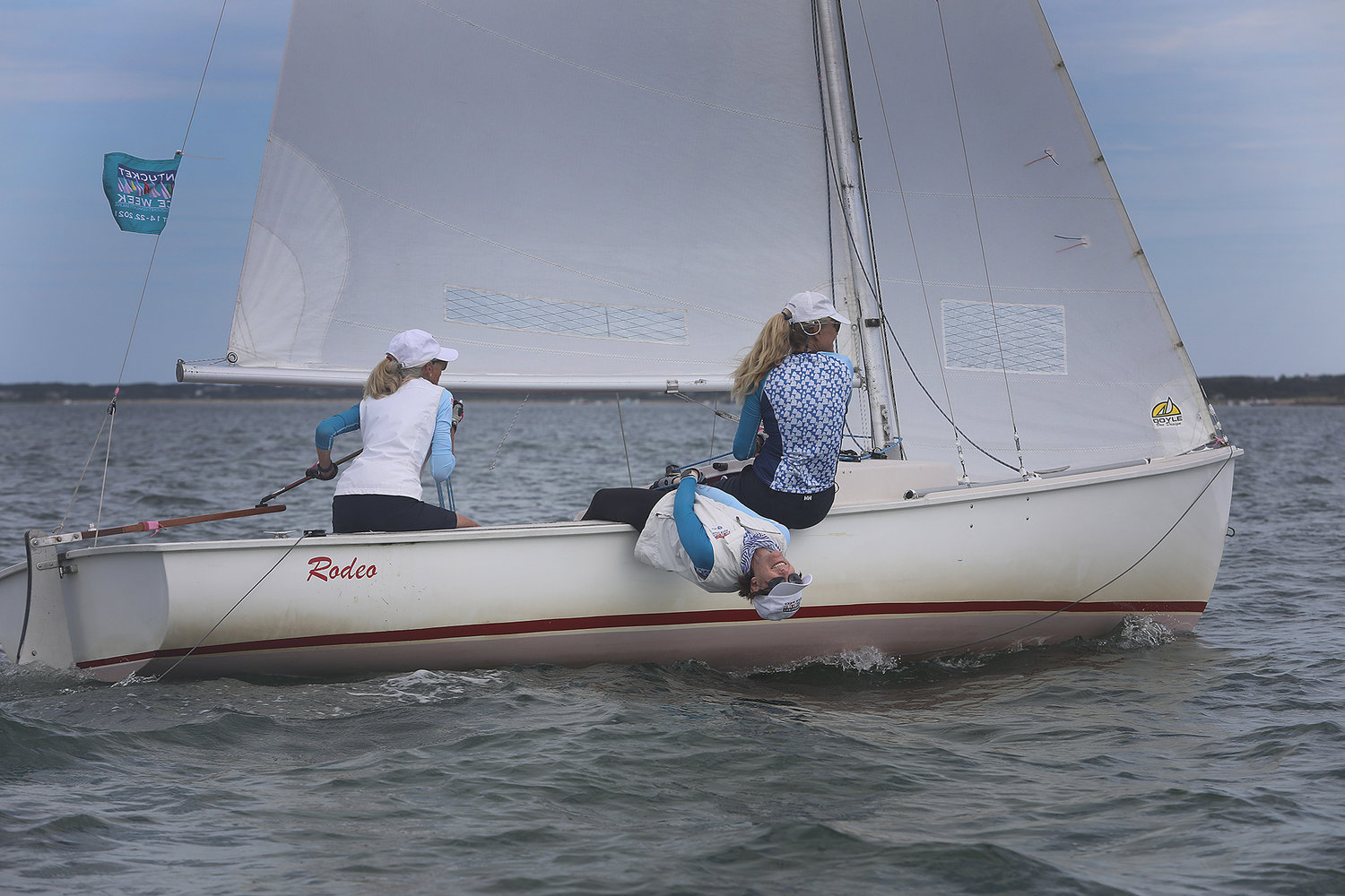 Kim Frisbie enjoys "hiking" aboard the Rodeo with Linda Johnson at the tiller and Minou Palandjian forward during the 2021 Women's Regatta in the harbor on Wednesday.