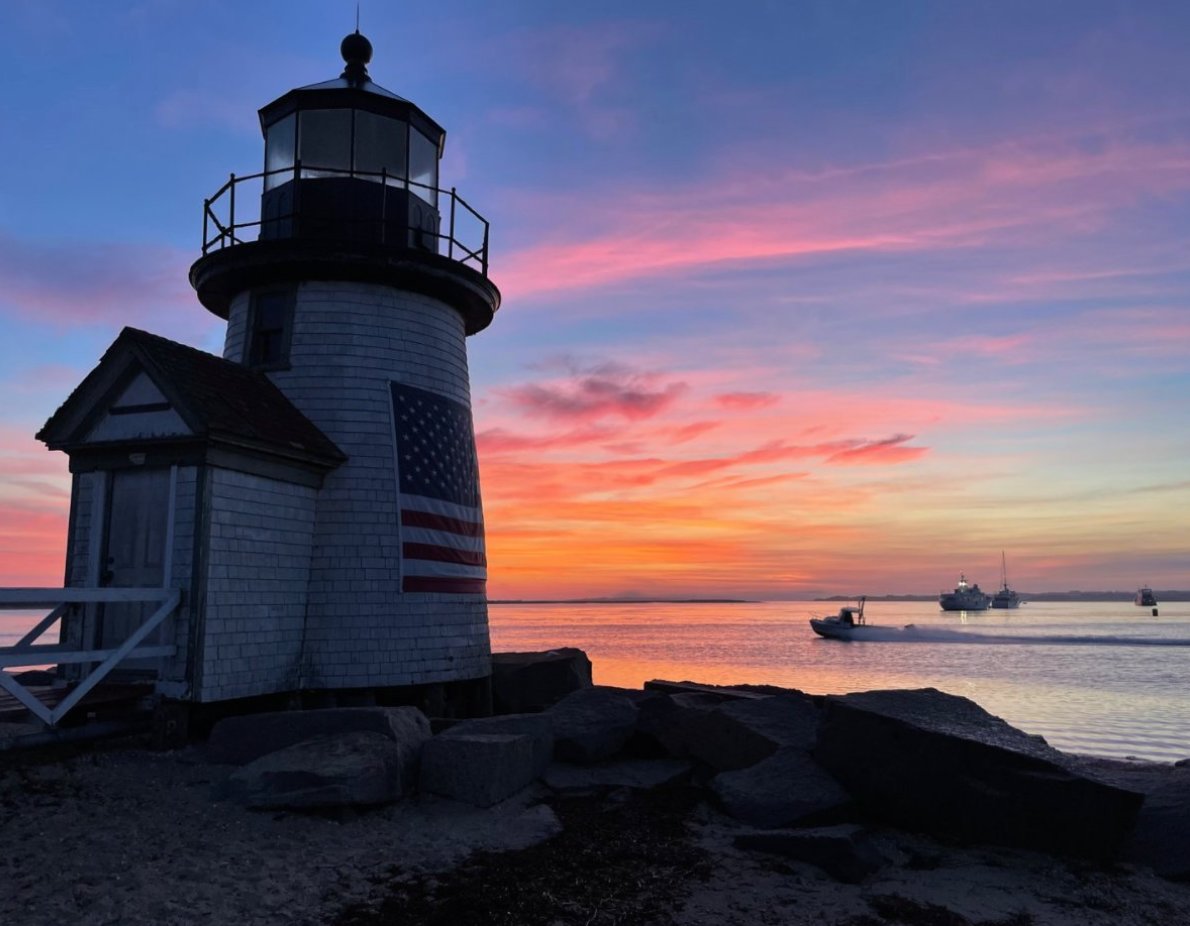 The sun rises over Brant Point Light and Nantucket Harbor last week.