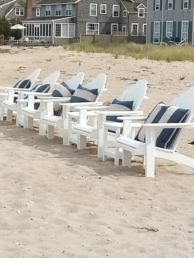 A line of empty beach shares stands sentinel on the beach.