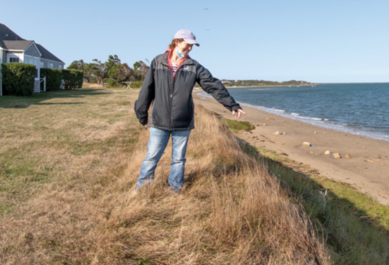 Yvonne Vaillancourt, director of the University of Massachusetts field station on Nantucket Conservation Foundation property in Quaise, points out erosion that has claimed nearly 80 feet of bluff in recent years.