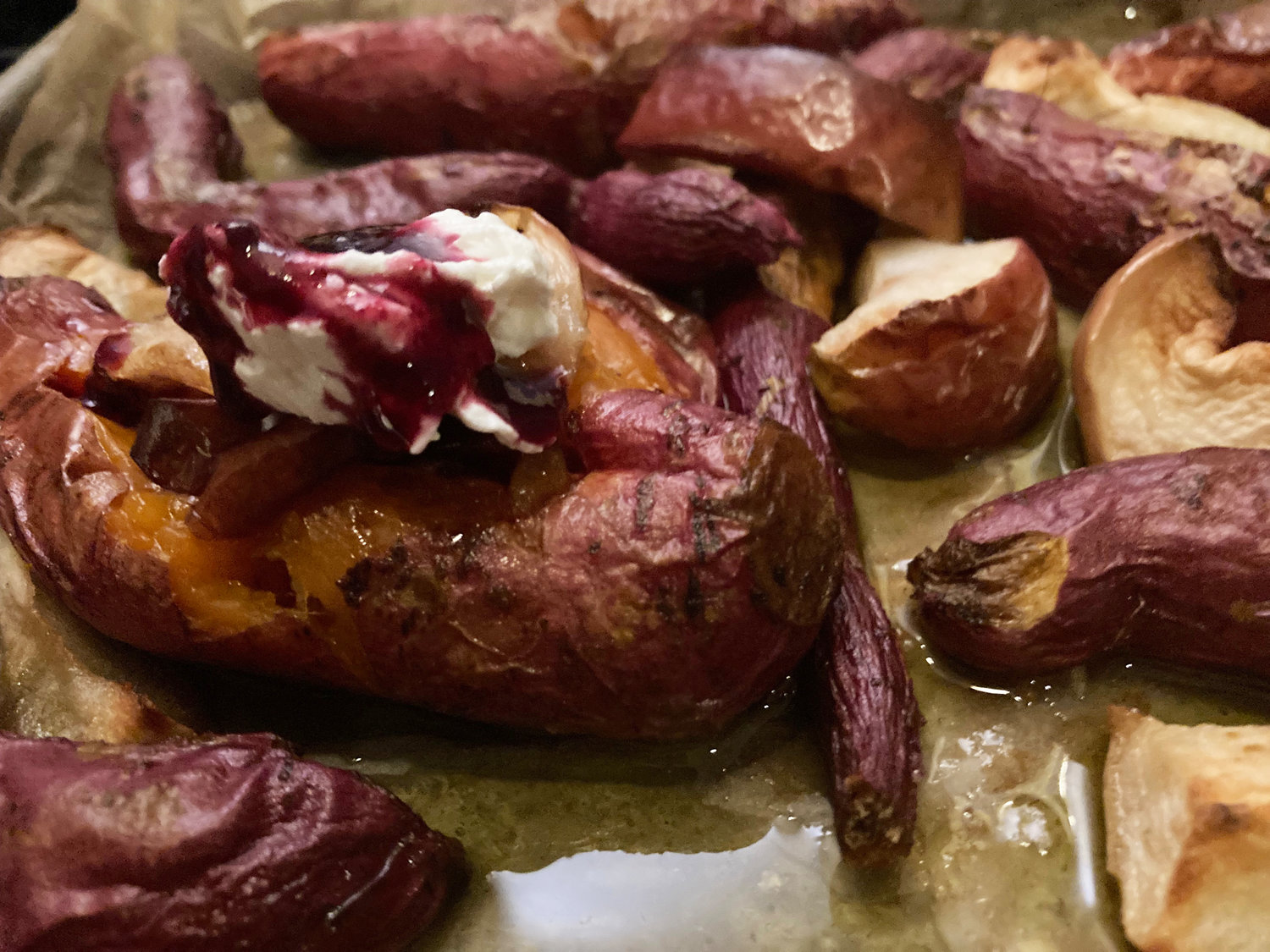 These roasted sweet potatoes are garnished with roasted apple pieces, Greek yogurt and a Concord grape drizzle.