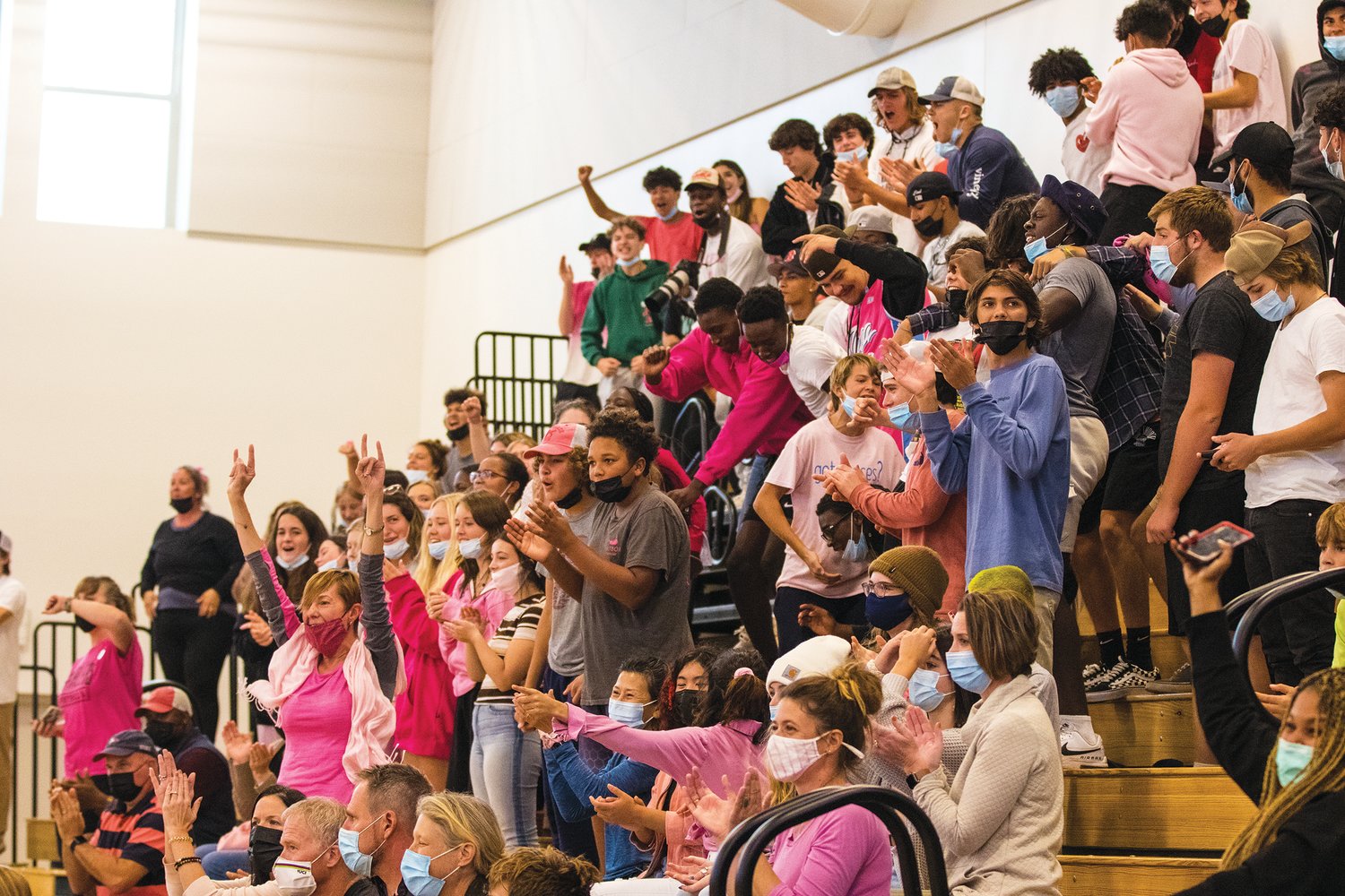 Fans wear pink during a volleyball game earlier in the fall.