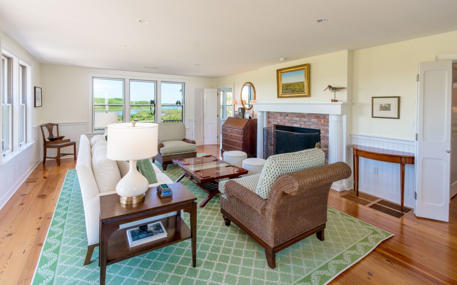 The family room has a brick fireplace and like much of the rest of the home, views of Polpis Harbor.