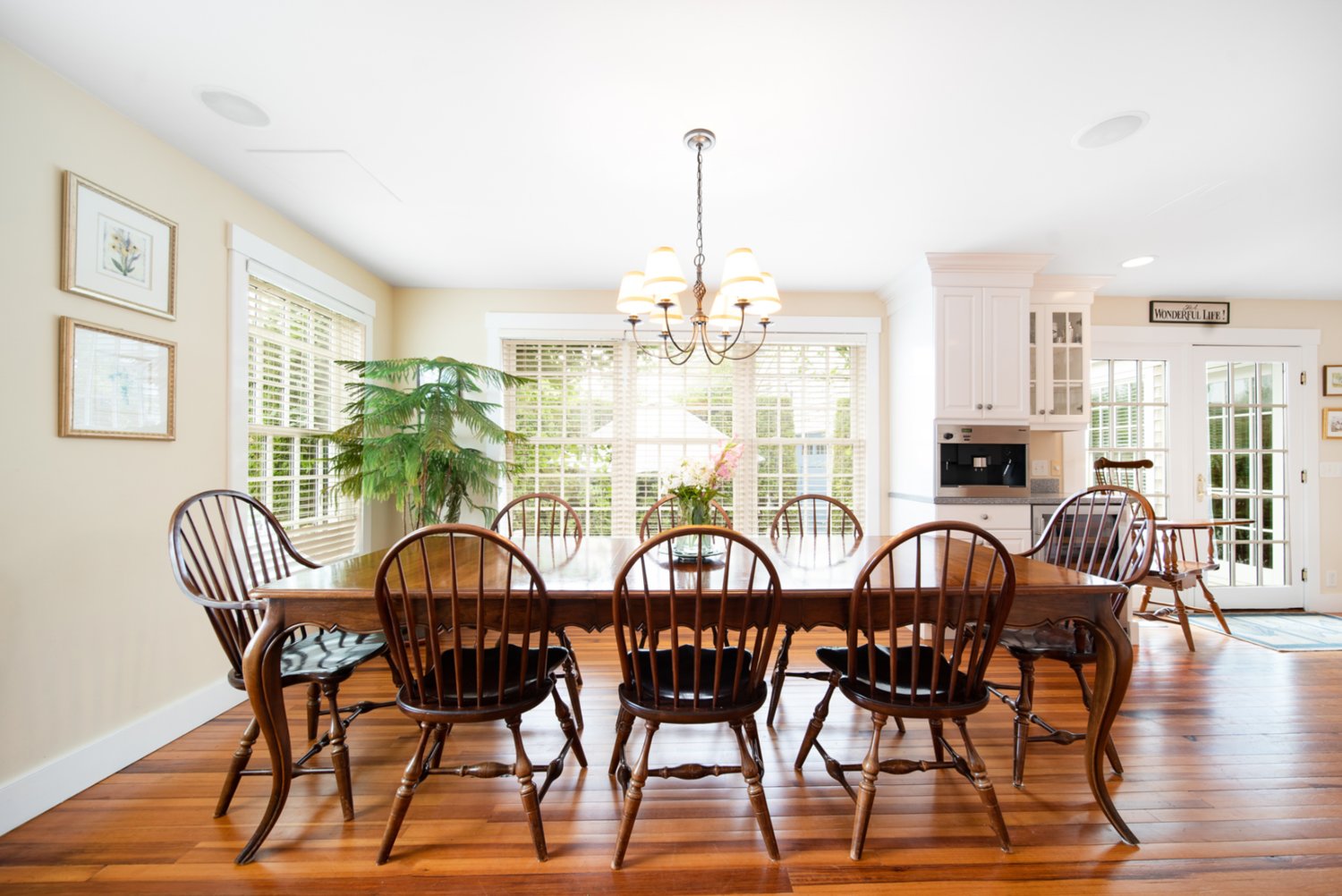 The dining area, located just off the kitchen, has glass doors that open directly to the back brick patio.