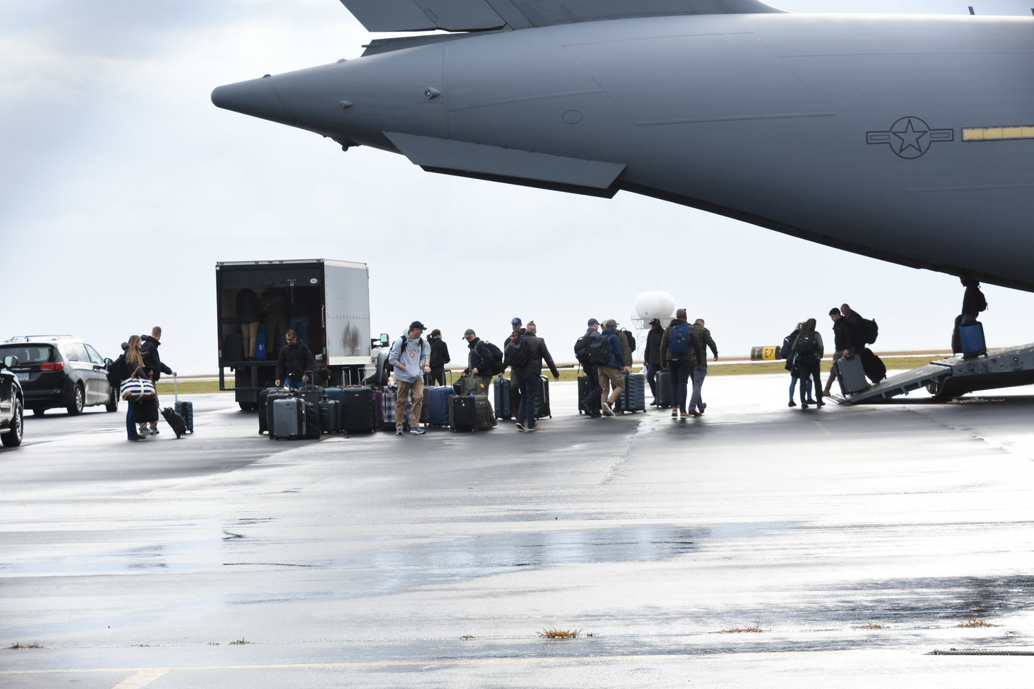 Several dozen people deplane from a U.S. Air Force C-17A Globemaster at Nantucket Memorial Airport Monday morning.
