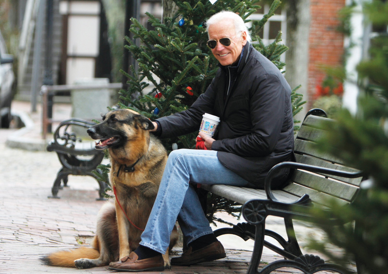 Then Vice-president Joe Biden relaxes on Main Street with his German shepherd Champ in 2013.