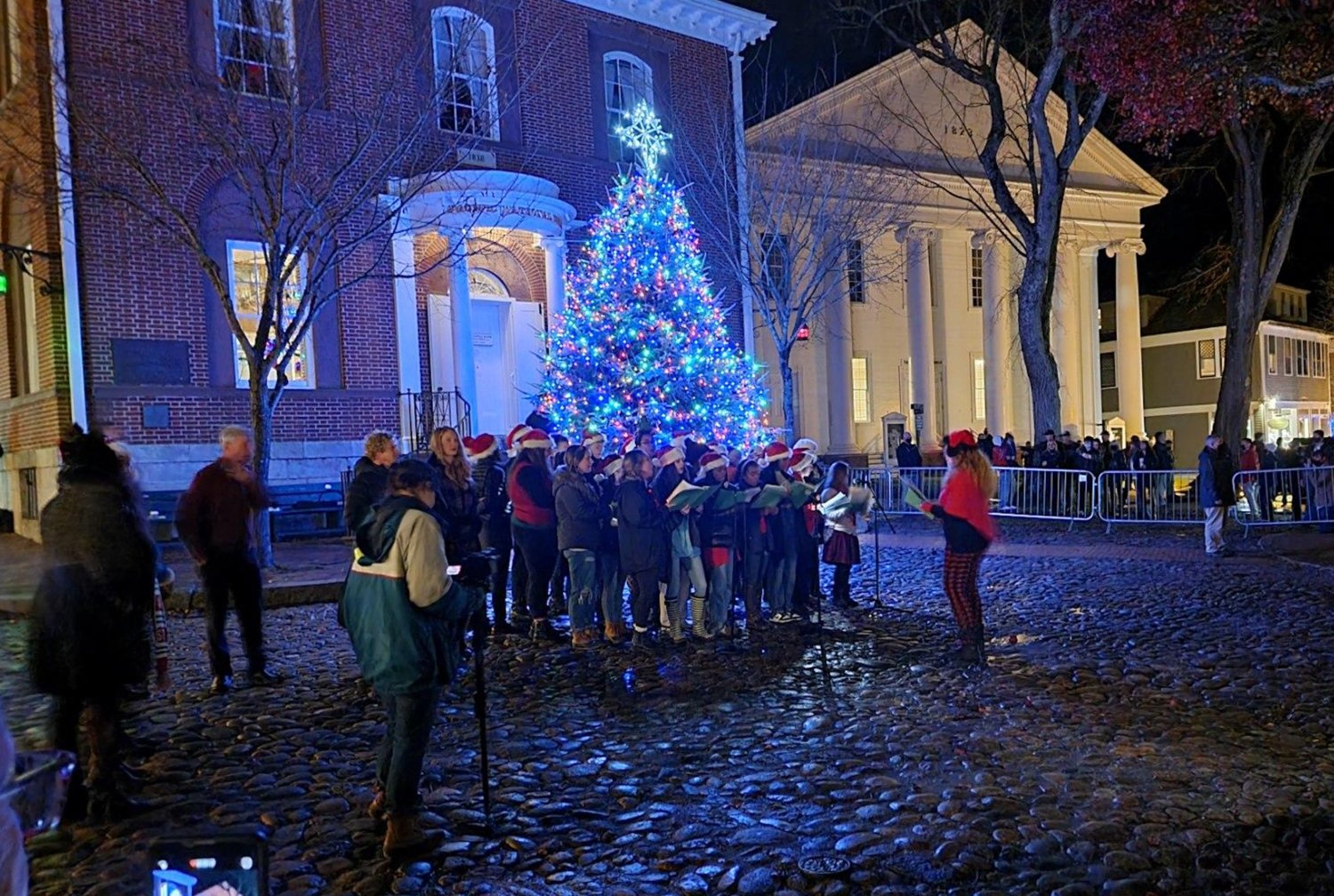 Metal barricades kept the crowd of more than 1,000 on Main Street away from the tree lighting and the Accidentals and Naturals Nantucket High School chorus Friday.