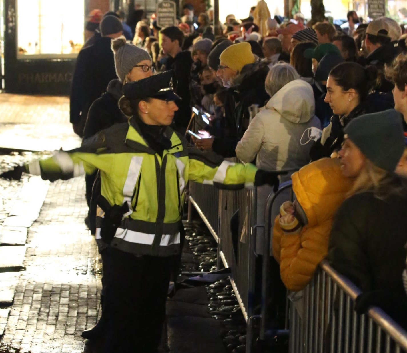Police keep the crowd on Main Street behind metal barricades during Friday's tree-lighting.
