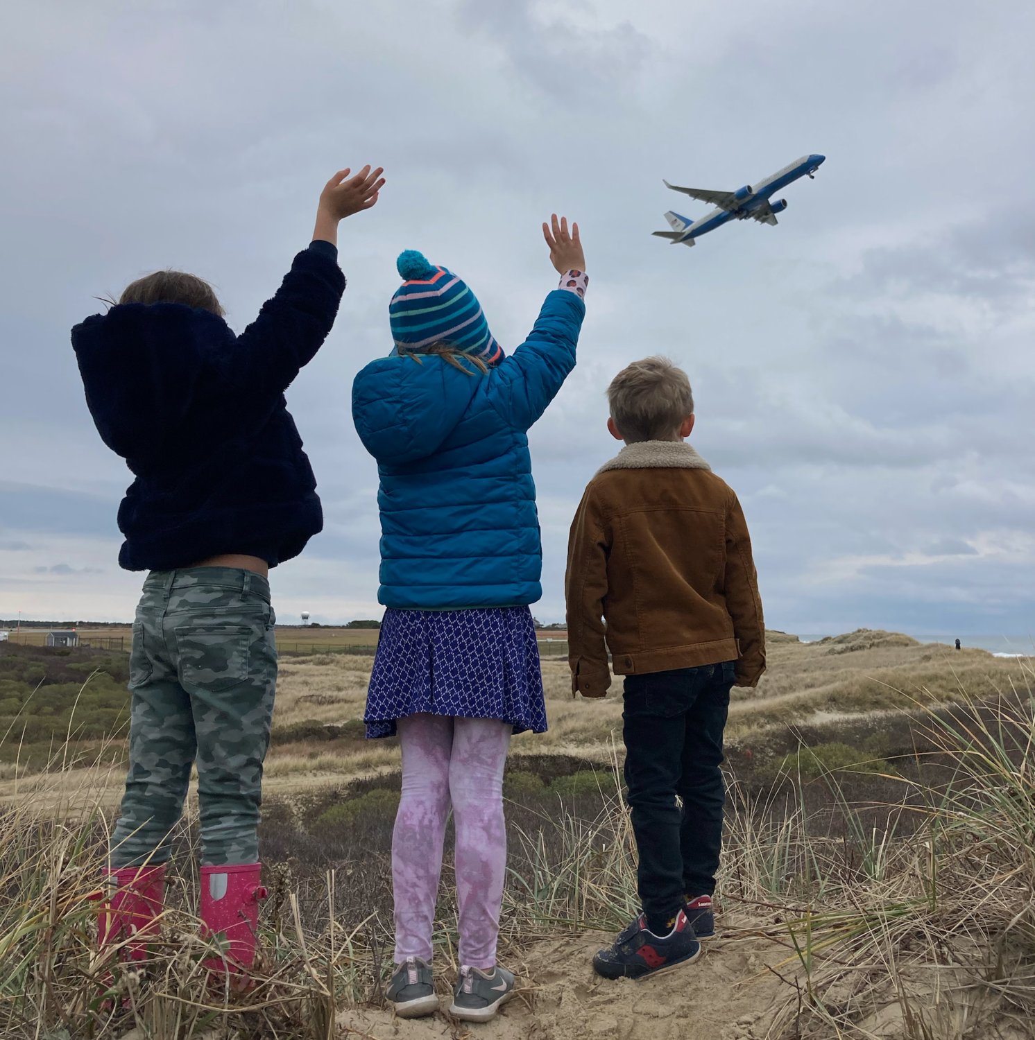 Waving goodbye to Air Force One as it departs Nantucket Memorial Airport Sunday.