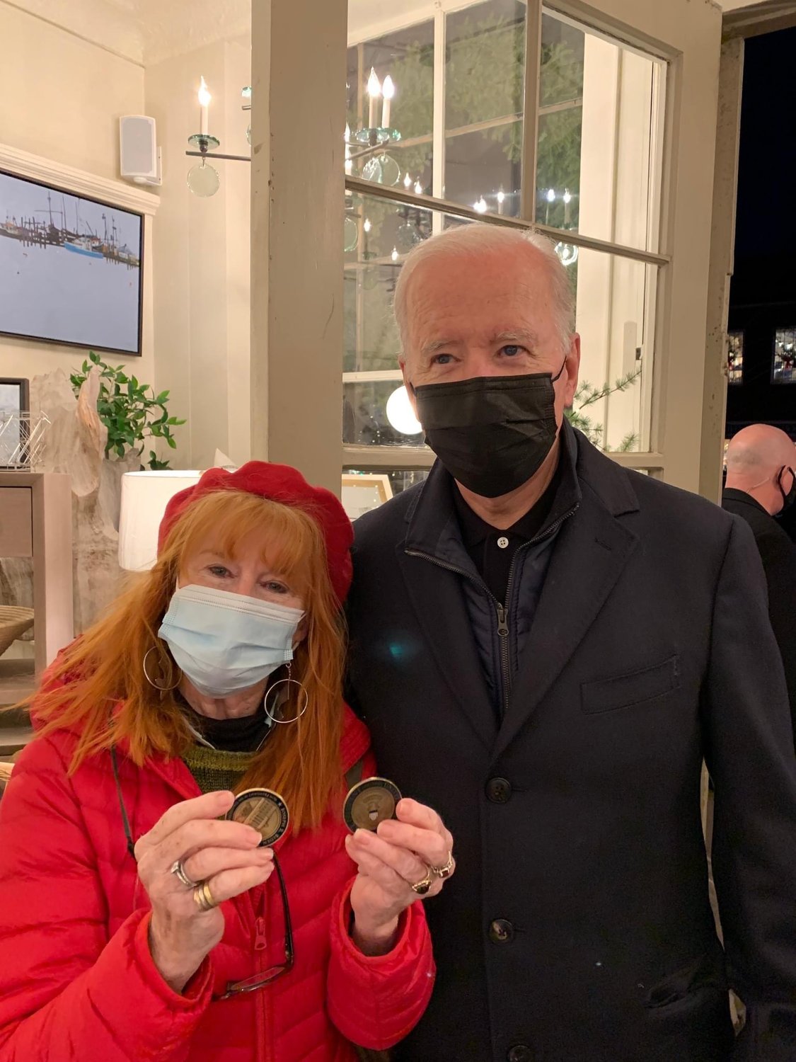 Susan Cary of Nantucket with President Biden and the two challenge coins he has given her, one during a previous visit, and one when she saw him at Nantucket Looms Saturday.