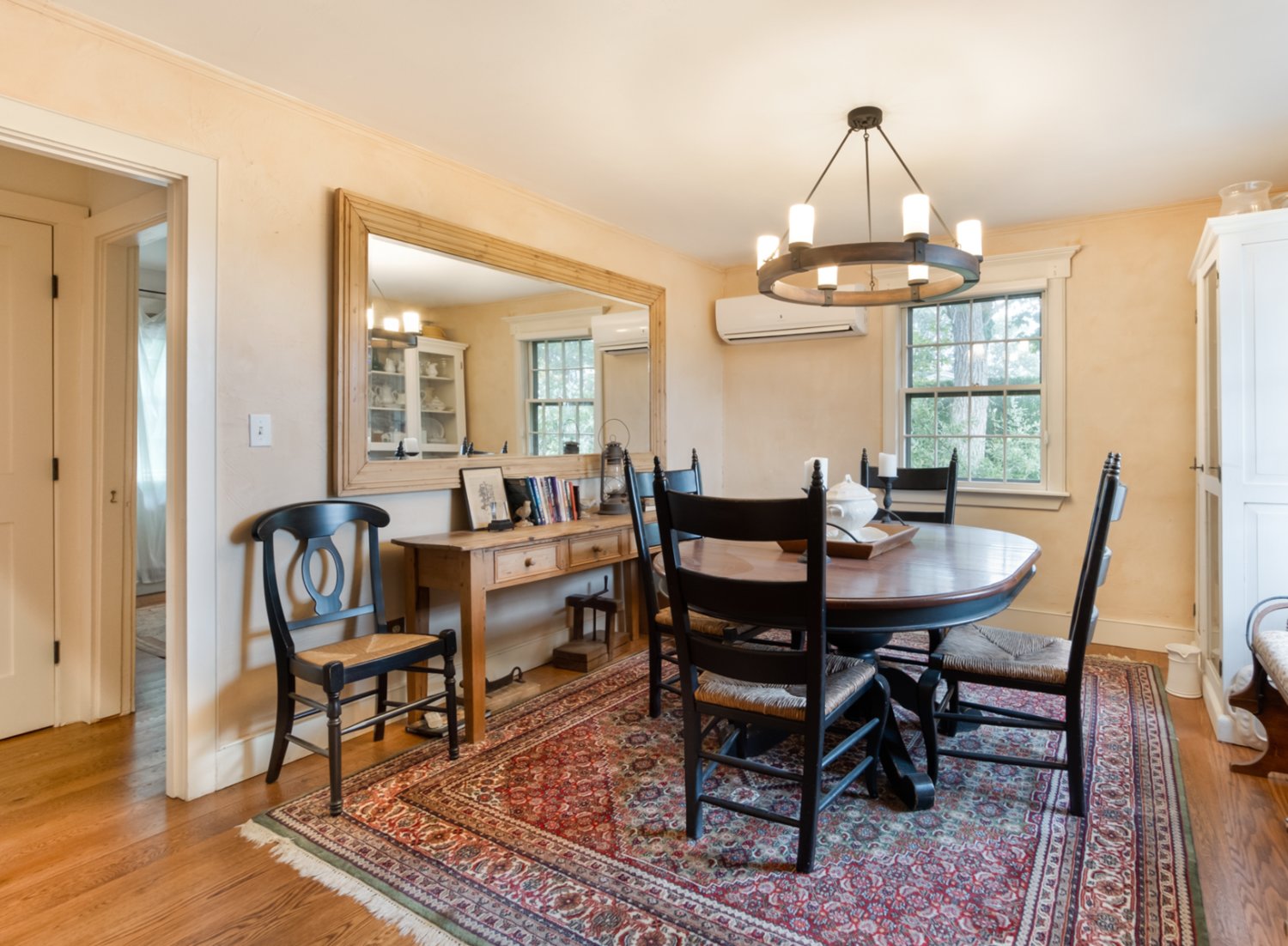 The dining room has wood floors and windows that let in an abundance of natural light.