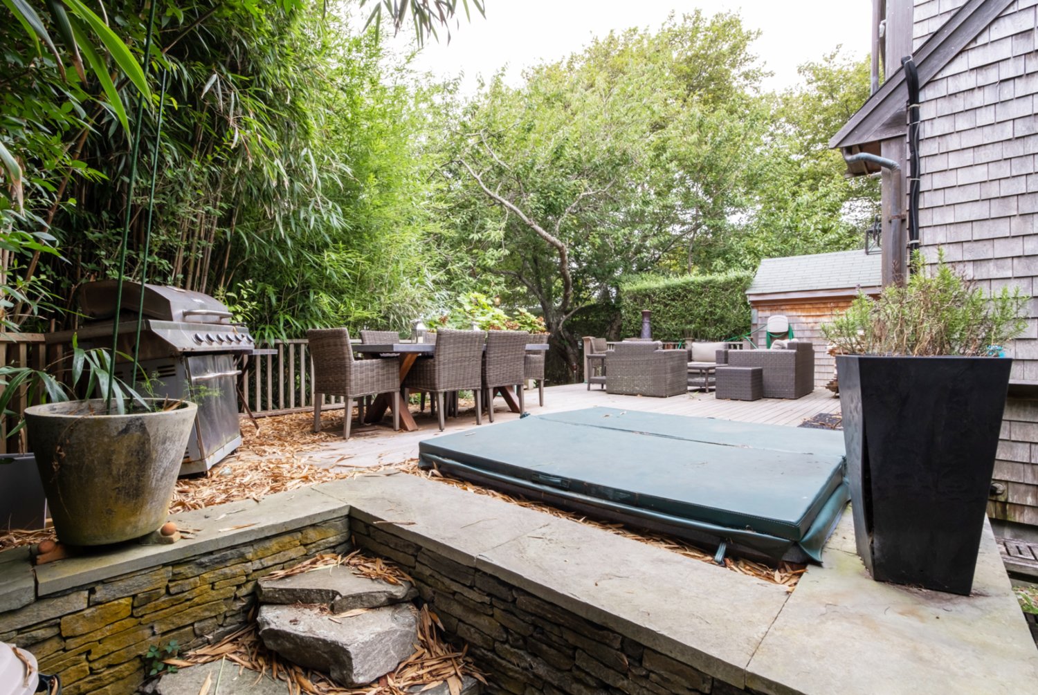 The stone patio has a hot tub and plenty of room for dining and entertaining.