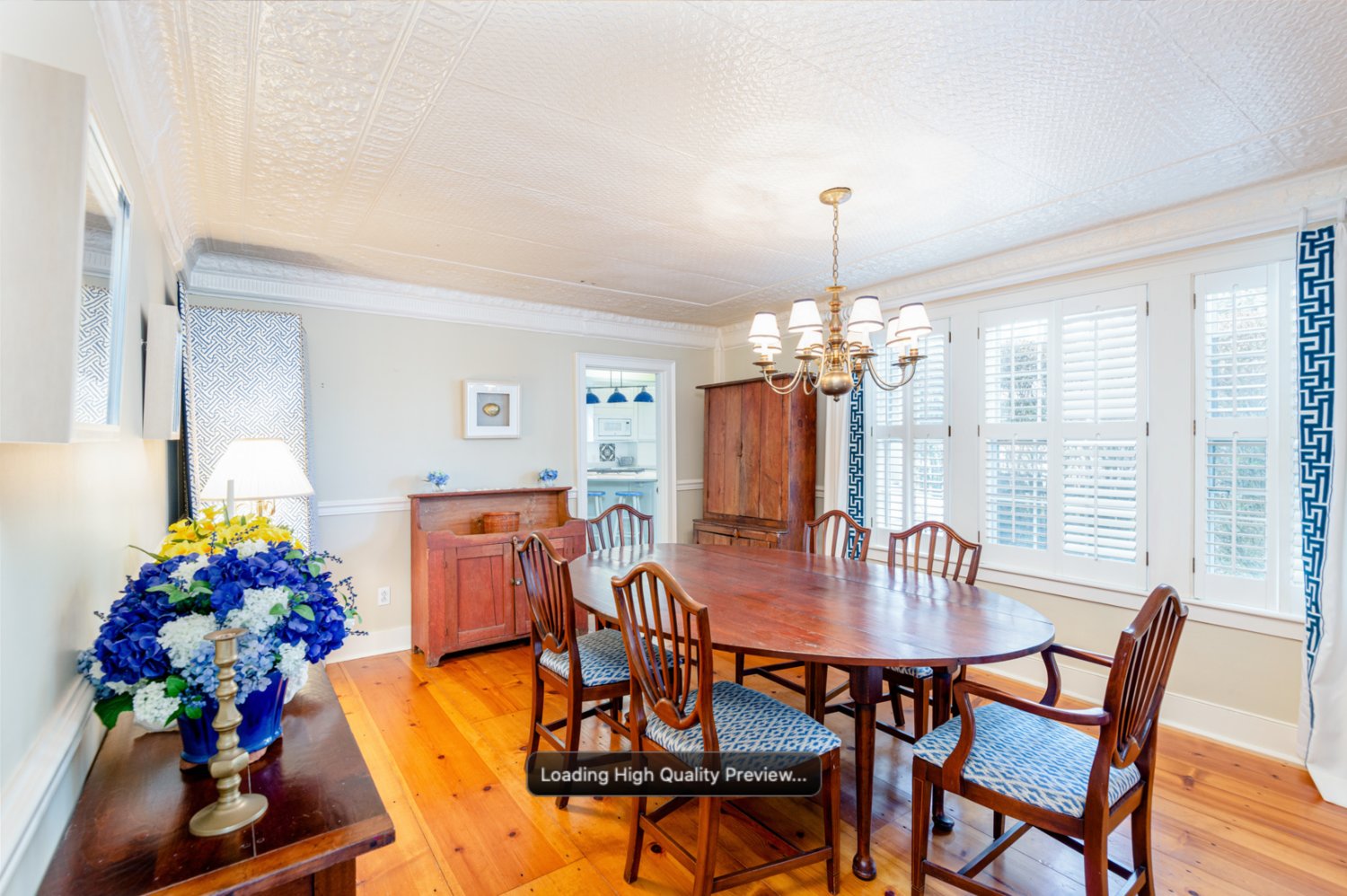 The formal dining room just off the kitchen has wide plank floors and plenty of windows that let in an abundance of natural light.
