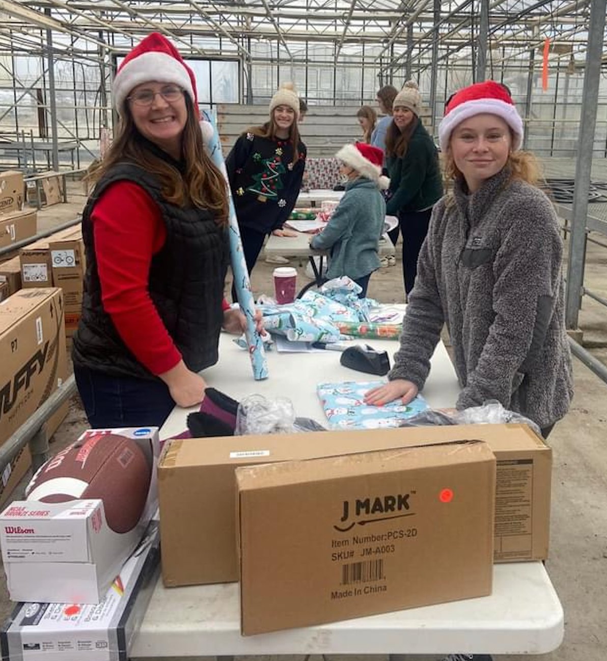Girl Scout troop 66120 members Tandi, Shelbi and Piper Harimon, Andrea and Aliza Mansfield help wrap presents for Inky Santa Sunday at Bartlett's Ocean View Farm.
