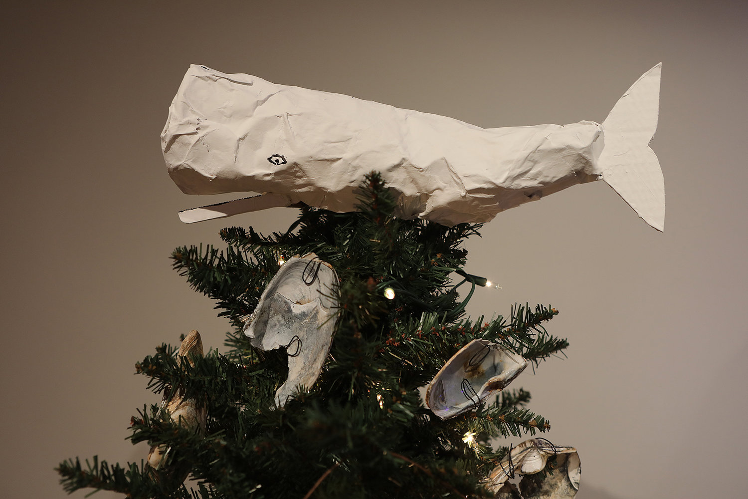 A white whale atop the Monica Seggos "Washashore" tree. Nantucket Historical Association Festival of Trees at the Whaling Museum.